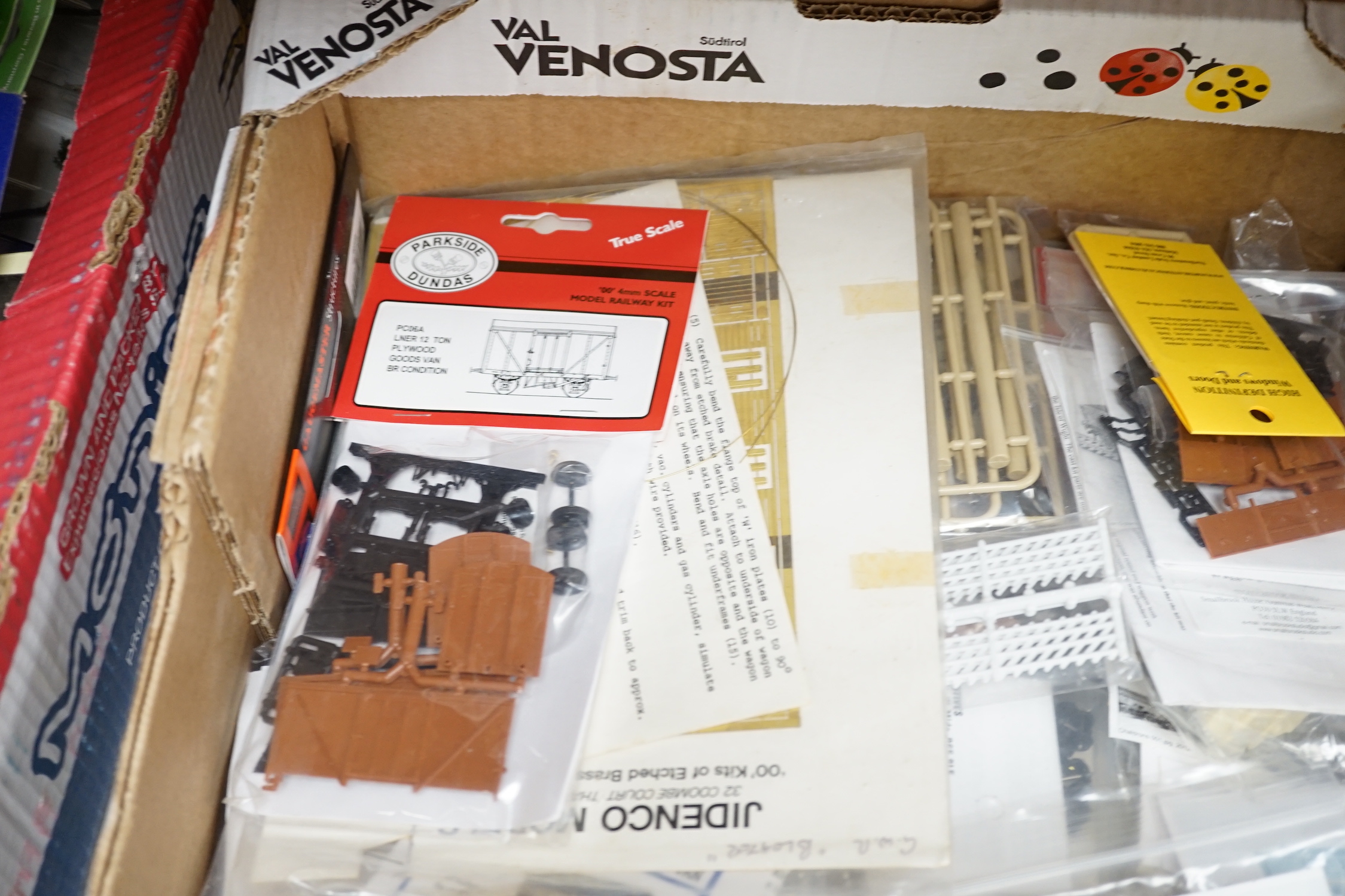 A collection of unmade, 4mm scale 00 gauge model, railway kits, and lineside accessories, including freight wagons, four-wheel coaches, commercial vehicles, etc. by Dapol, Cooper Craft, Parkside Dundas, etc. together wit